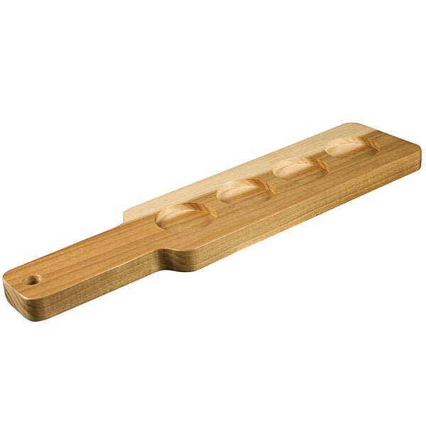 A wooden paddle with four holes in it.