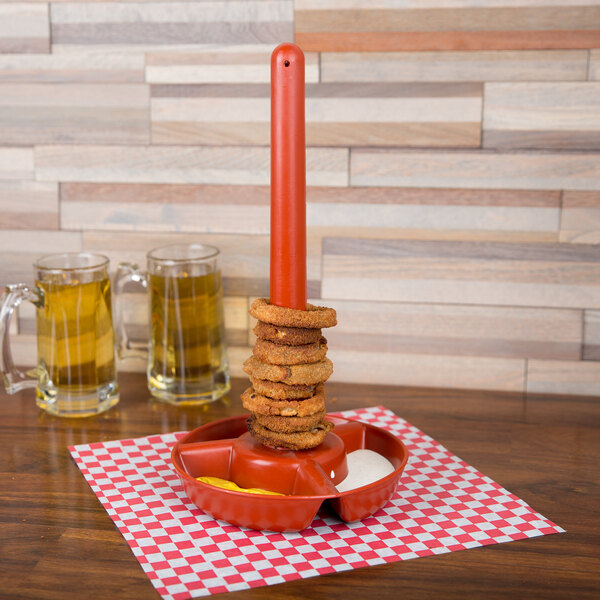 A stack of rings on a red plate with a red handle.