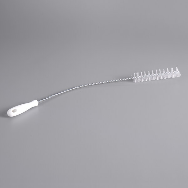 A white wire brush with a white handle.
