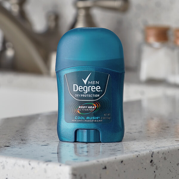 A blue bottle of Degree Men Cool Rush deodorant on a counter.