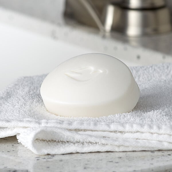 A white Dove Beauty Bar soap on a towel.