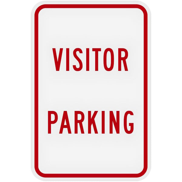 A white sign with red text that says "Visitor Parking" on it.