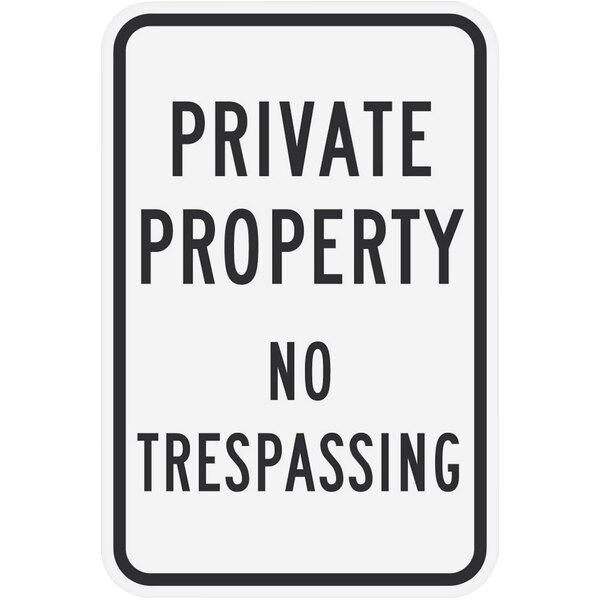 A white rectangular sign with black text that says "Private Property / No Trespassing"