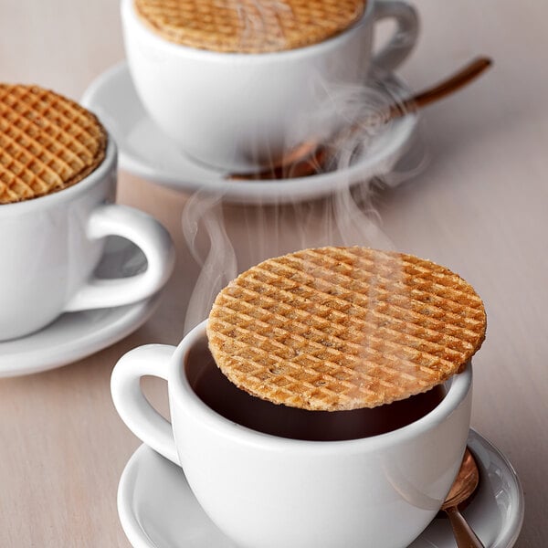 A Lancaster Stroopie cookie with a waffle crust on top of a cup of coffee.