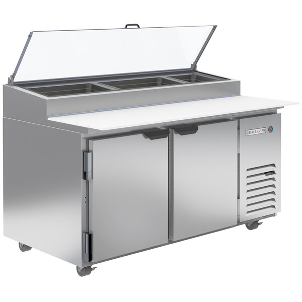 A Beverage-Air stainless steel refrigerated pizza prep table with two clear lids.