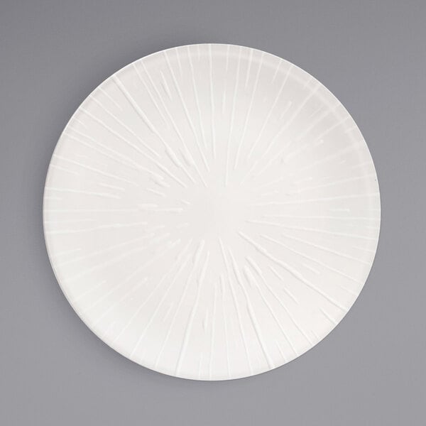 A Front of the House European White porcelain plate with circular lines on the edge.