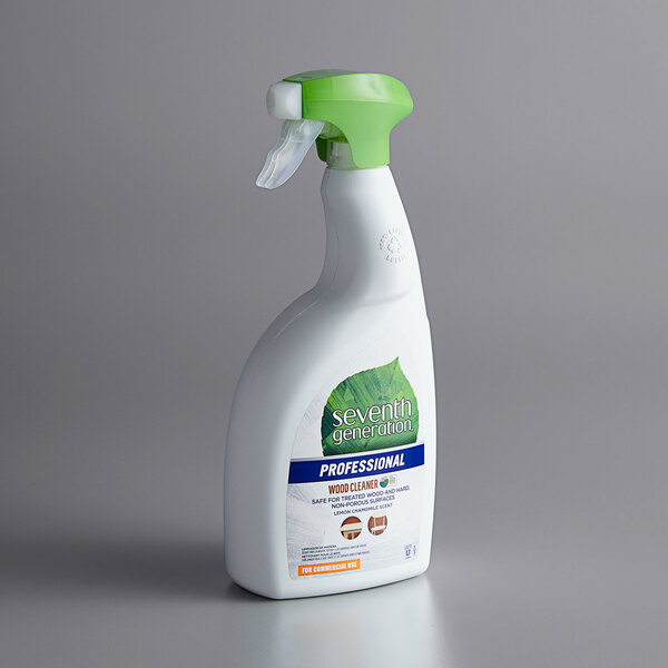 A white spray bottle of Seventh Generation Lemon Chamomile wood surface cleaner with a green lid.
