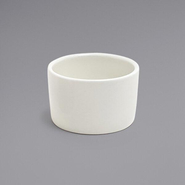 A white round porcelain ramekin on a gray surface.