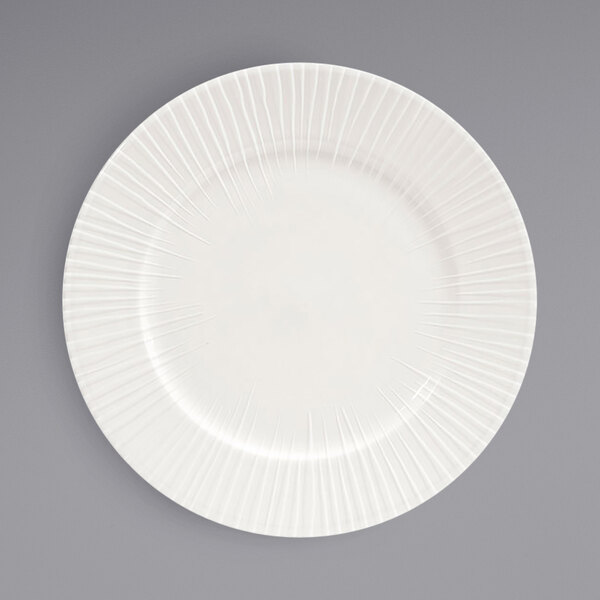 A white plate with an embossed spiral design.
