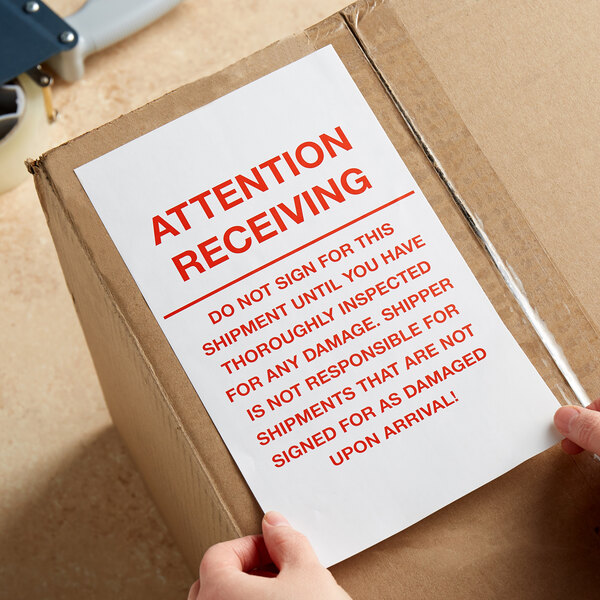A person holding a Lavex attention receiving label.