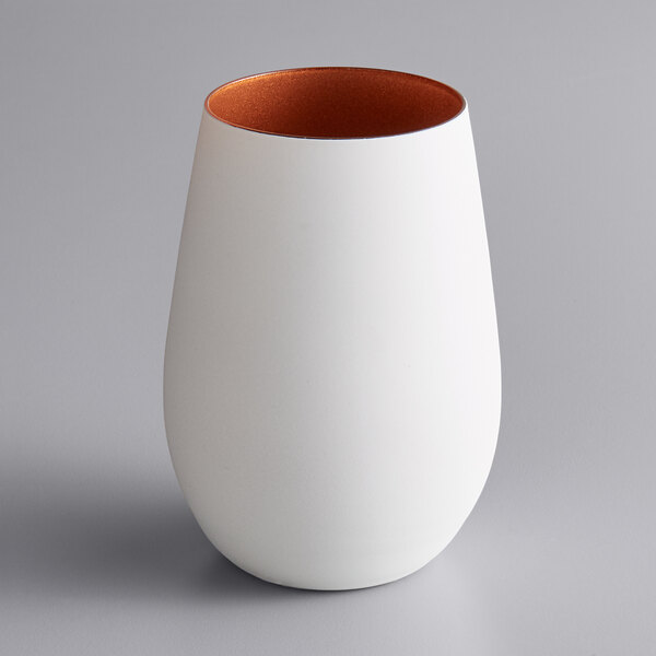 A Stolzle matte white and copper stemless wine glass.