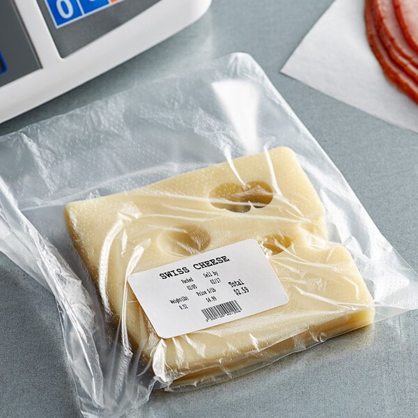 A package of cheese in a white plastic bag on a counter with a Tor Rey white scale label.