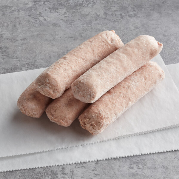 Three frozen Beyond Meat original bratwurst sausages on a napkin.