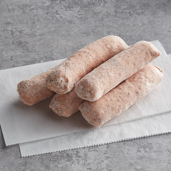 Three Beyond Meat plant-based Italian Bratwurst sausage rolls on a white surface.