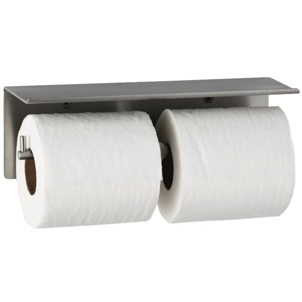 A Bobrick multi roll toilet paper dispenser with two rolls of toilet paper on a metal holder.