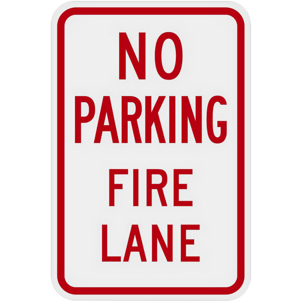 A white sign with red text that says "No Parking / Fire Lane" and a red border.