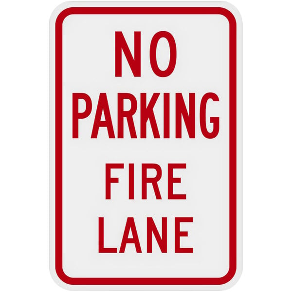 A white rectangular sign with red text that reads "No Parking / Fire Lane" and a red border.