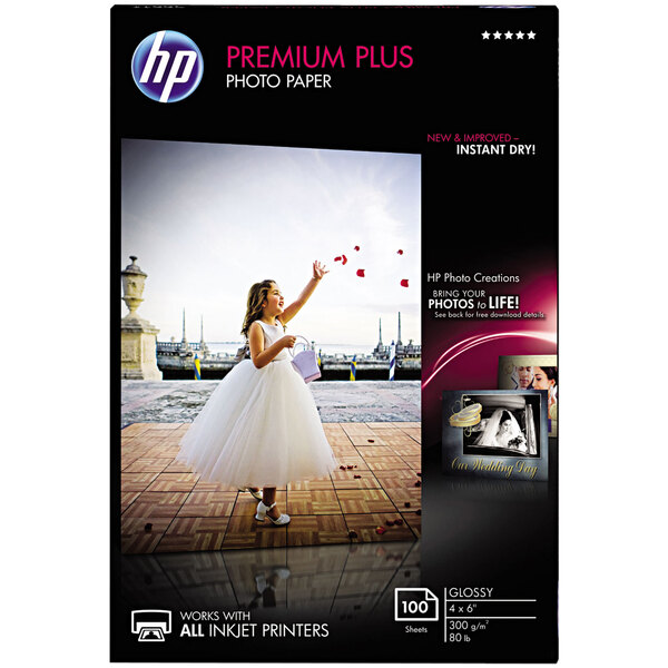 A box of HP Premium Plus glossy white photo paper.