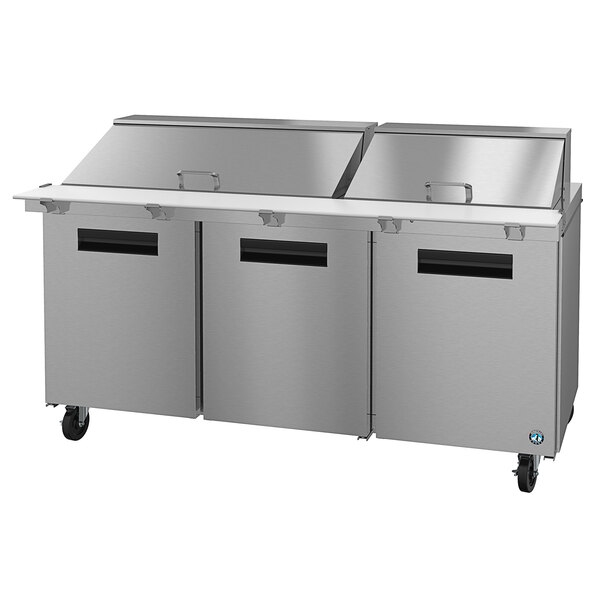 A stainless steel Hoshizaki commercial sandwich prep table with three doors.