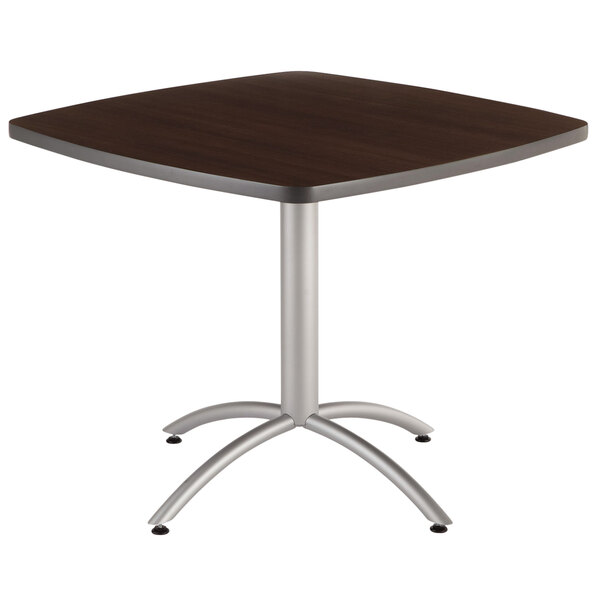 A Iceberg square table with a walnut top and silver metal base.