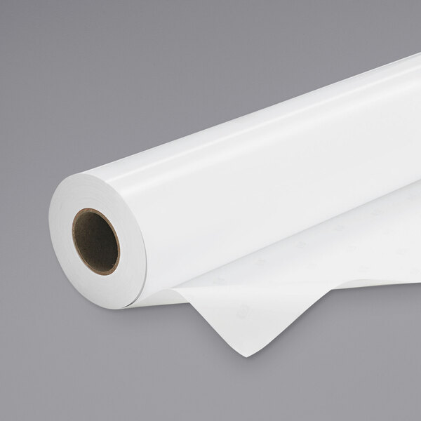 A roll of HP Glossy White Premium Photo Paper on a white surface.