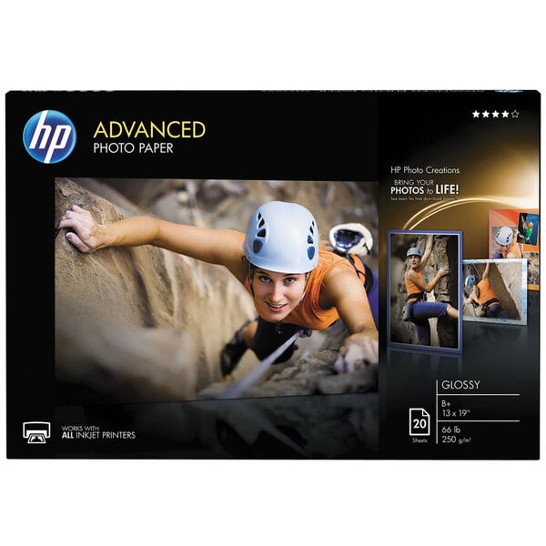 A package of HP Advanced glossy white photo paper with a photo of a woman climbing a rock wall.