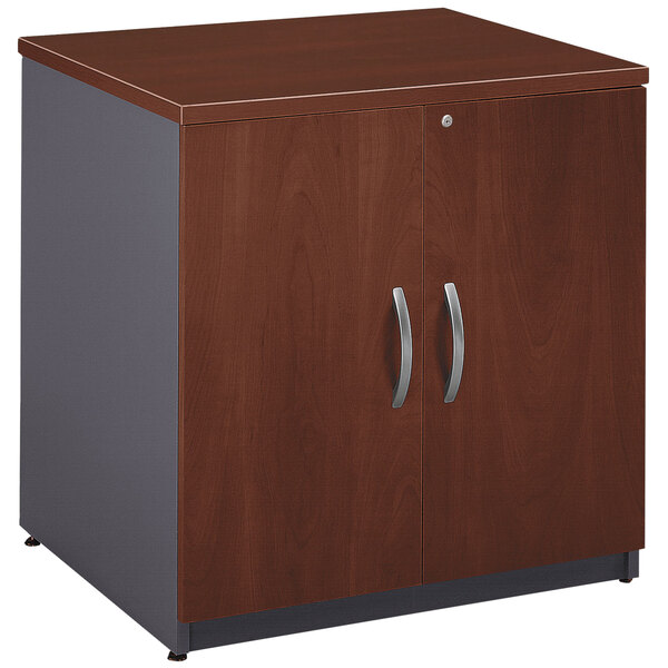 A Bush Hansen Cherry office cabinet with two doors.