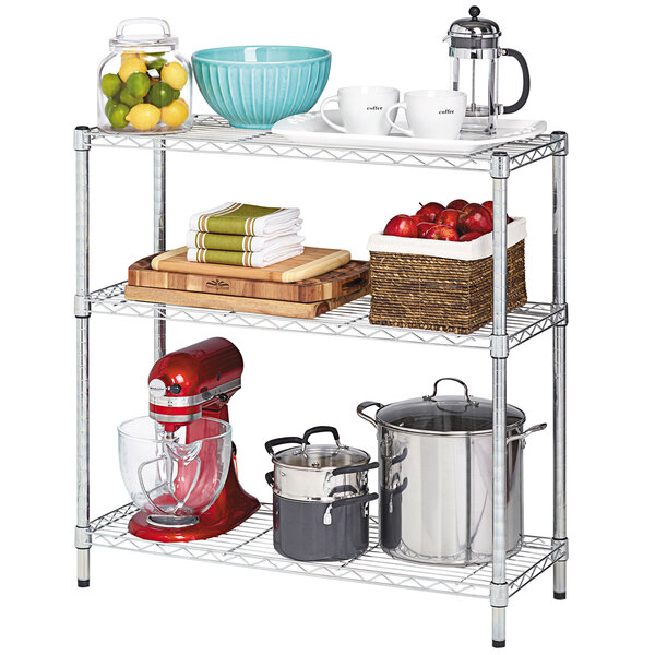 An Alera steel wire shelf in a professional kitchen with food items on it.