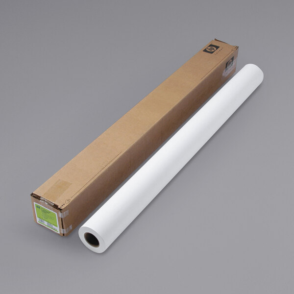 A roll of HP white large format paper next to a cardboard box.