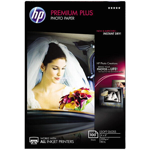 A box of HP Premium Plus photo paper with white packaging.