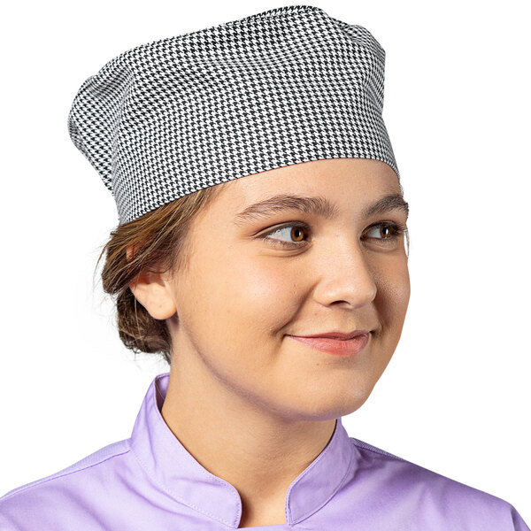 A woman wearing a Uncommon Chef houndstooth chef hat.