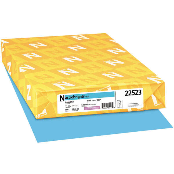 A yellow package with white letters that reads "Astrobrights Lunar Blue" containing blue paper.