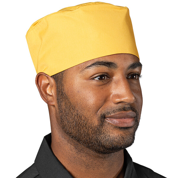 A man wearing an Epic Sunflower chef skull cap with a yellow sunflower pattern.