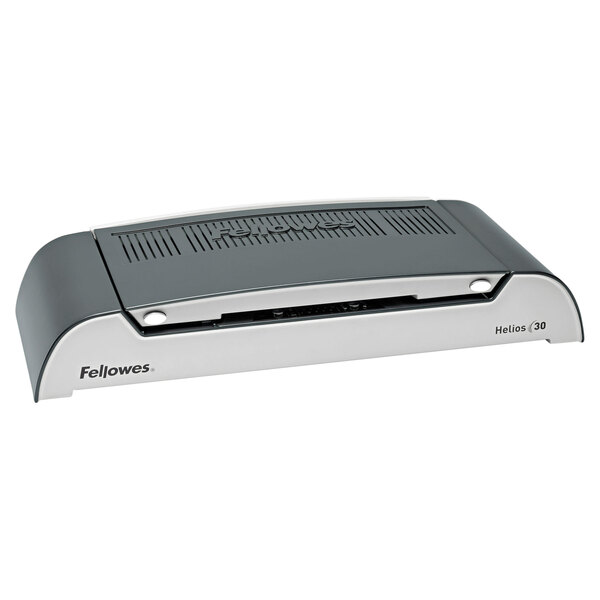A black and silver Fellowes Helios thermal binding machine with a black cover.