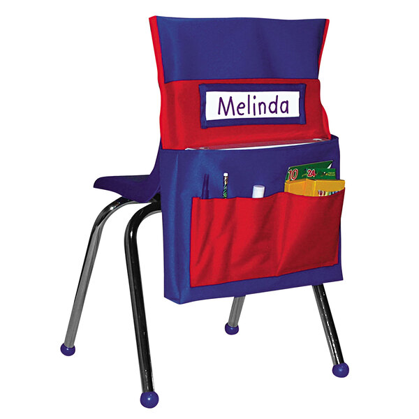 A blue and red Carson Dellosa chairback buddy pocket on a chair with a name tag.