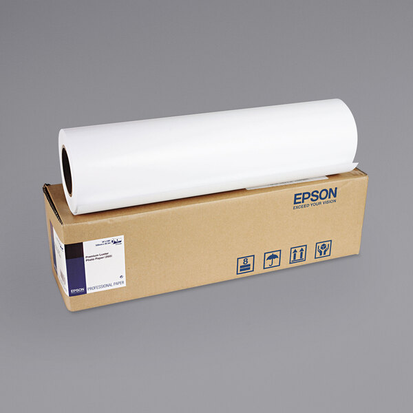 A roll of Epson white premium photo paper on a brown cardboard box.