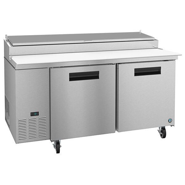 A stainless steel refrigerated counter with two doors.