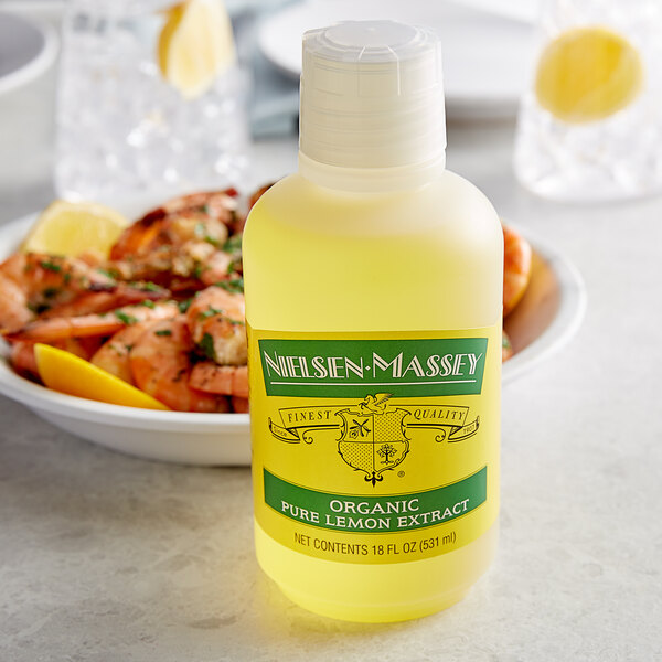 A bottle of Nielsen-Massey Pure Organic Lemon Extract on a white surface with a black stripe.
