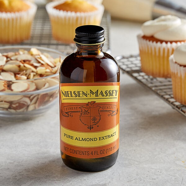 A bottle of Nielsen-Massey Pure Almond Extract on a counter.