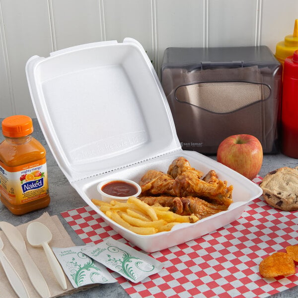 A white Dart foam takeout container with chicken wings and fries.