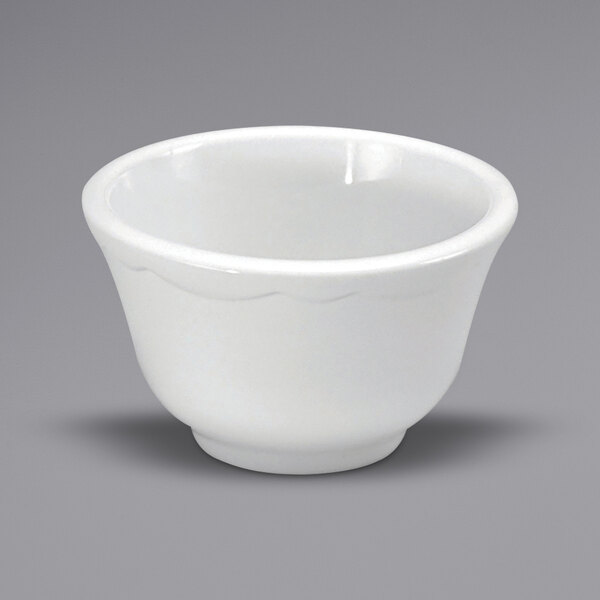 A close up of a Oneida Buffalo Caprice cream white china bowl with scalloped edges.