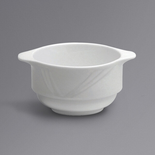 A close-up of a white Oneida Buffalo Arcadia bouillon bowl with handles.
