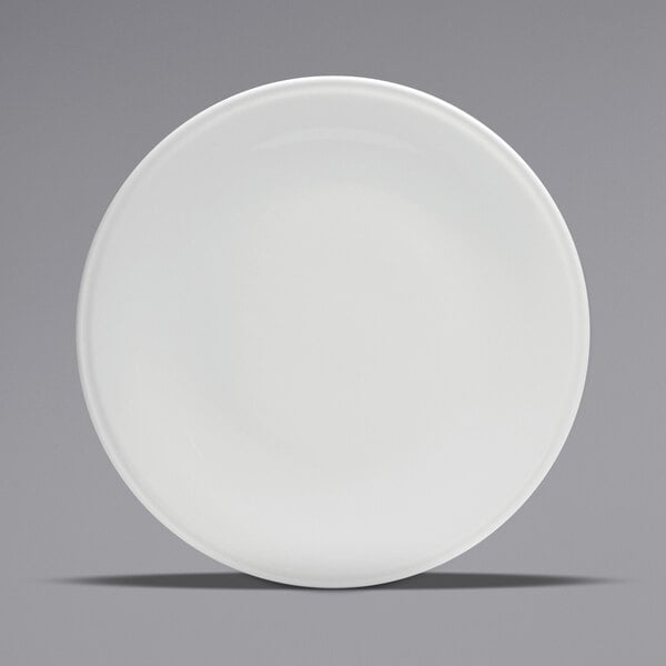 A close up of a white Oneida Buffalo porcelain pizza plate with a rolled edge.