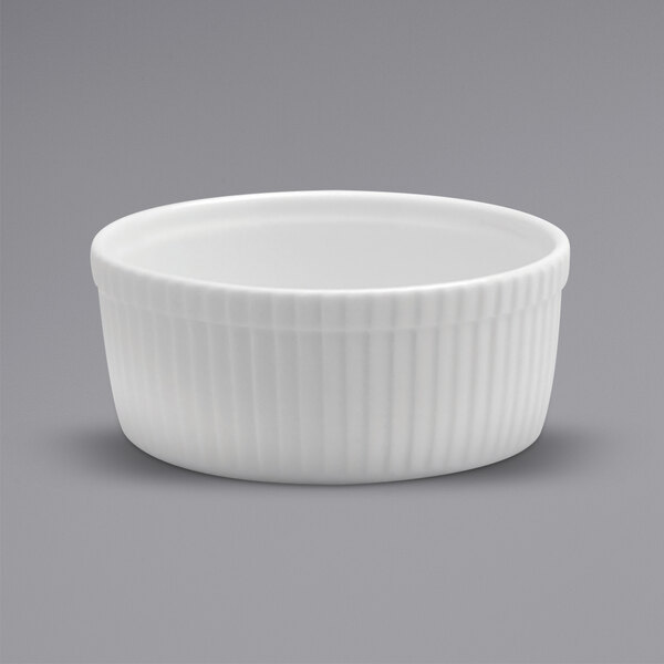 A Oneida Buffalo Bright White Ware fluted porcelain souffle dish with a ribbed rim.