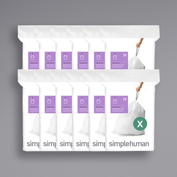 A group of simplehuman white trash can liners with an orange label.