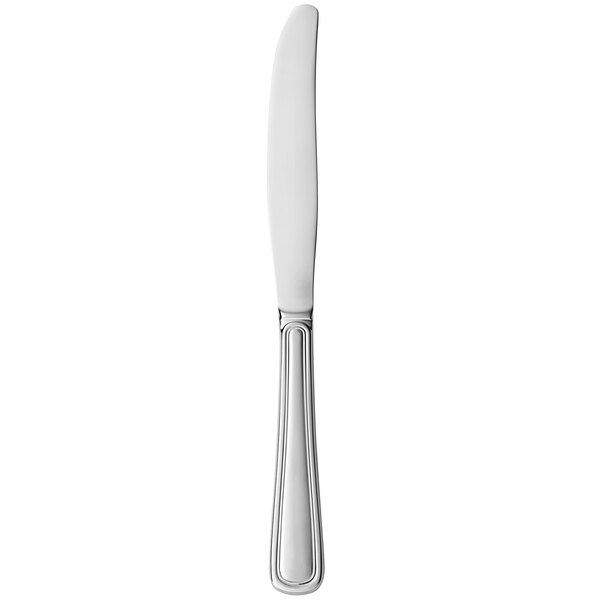 A silver Libbey stainless steel dinner knife with a fluted blade on a white background.
