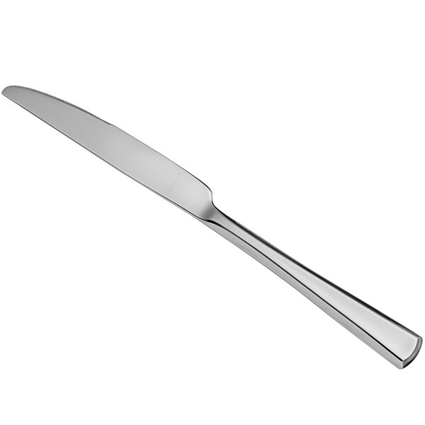 A Libbey stainless steel dinner knife with a white handle.