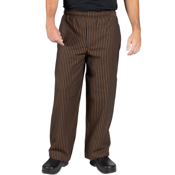 A person wearing black and copper striped chef pants.