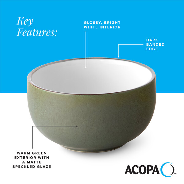 A stoneware bowl with a warm green matte speckled exterior, a glossy white interior, and a dark banded edge.