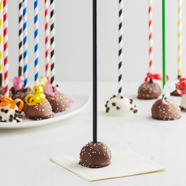 EcoChoice black paper cake pop sticks in a group of chocolate cake pops.